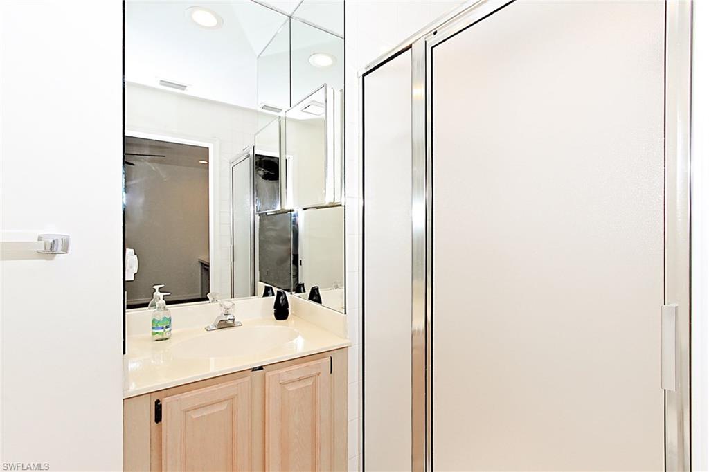 192 Napa Ridge Road East, Unit 4 Naples, FL 34119 - Photo 20 of 28 a bathroom with a sink and a mirror