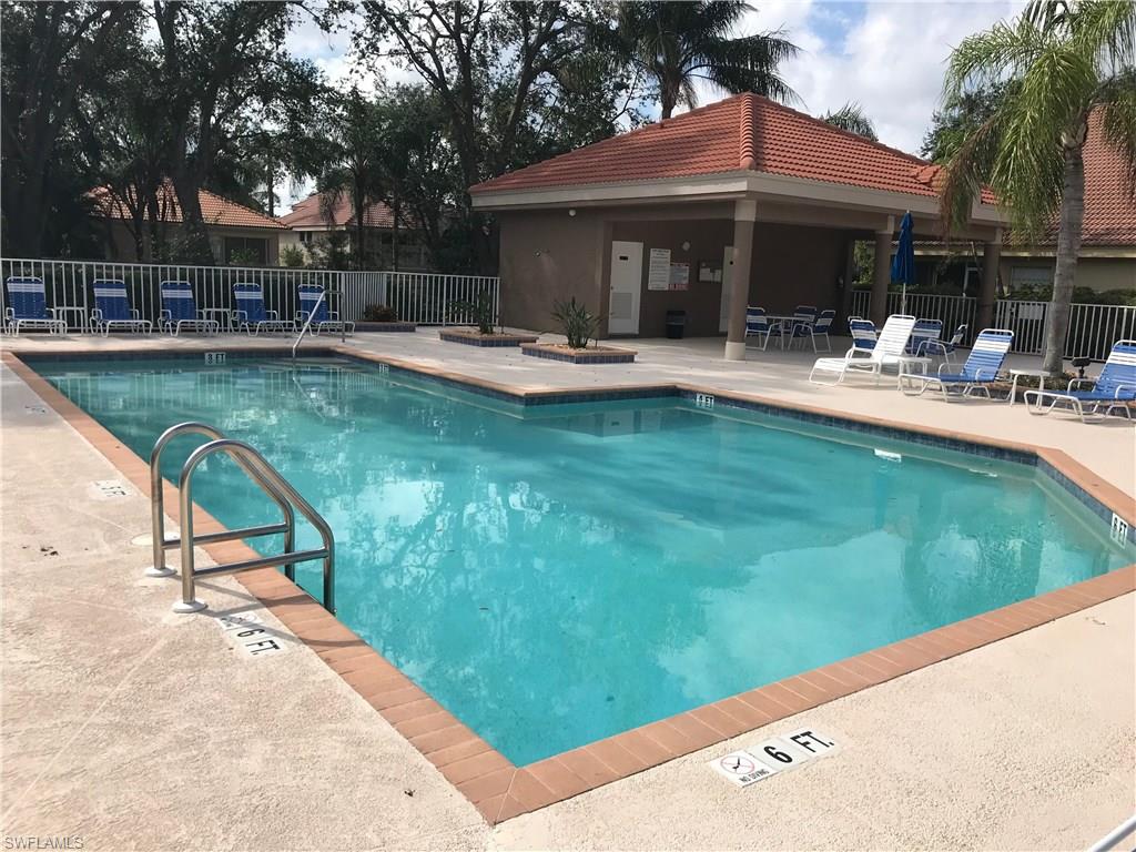 192 Napa Ridge Road East, Unit 4 Naples, FL 34119 - Photo 25 of 28 a view of a swimming pool with chairs
