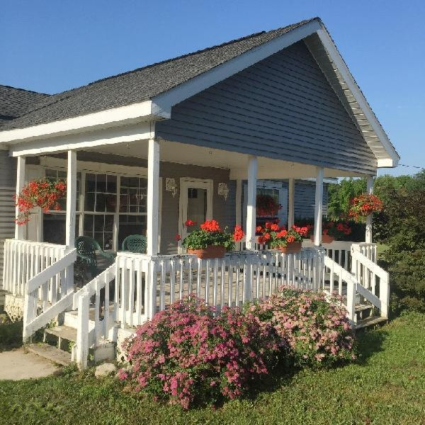9055 Potter Road Bear Lake, MI 49614 - Photo 2 of 28 Exceptional covered front porch!