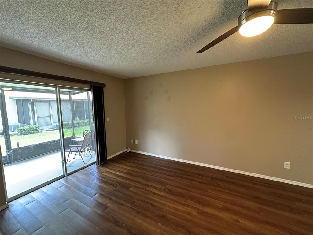 2440 Enterprise Road, Unit 2 Clearwater, FL 33763 - Photo 11 of 19 a view of an empty room with wooden floor and a window