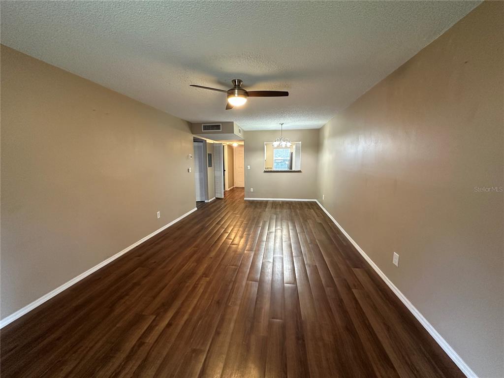 2440 Enterprise Road, Unit 2 Clearwater, FL 33763 - Photo 12 of 19 wooden floor in an empty room with a window