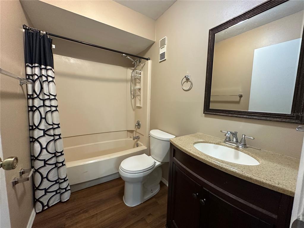 2440 Enterprise Road, Unit 2 Clearwater, FL 33763 - Photo 15 of 19 a bathroom with a sink a toilet a mirror a bathtub and shower