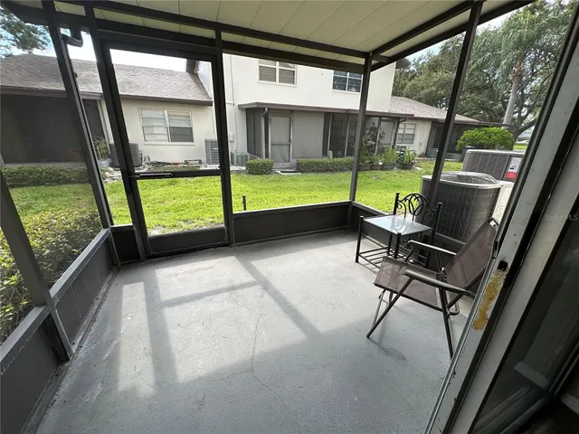 a view of a porch with furniture and garden