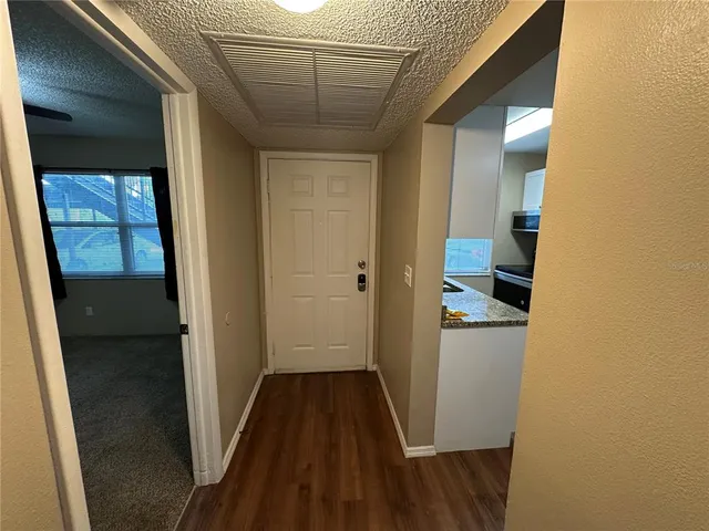 a view of a hallway with wooden floor and a hallway