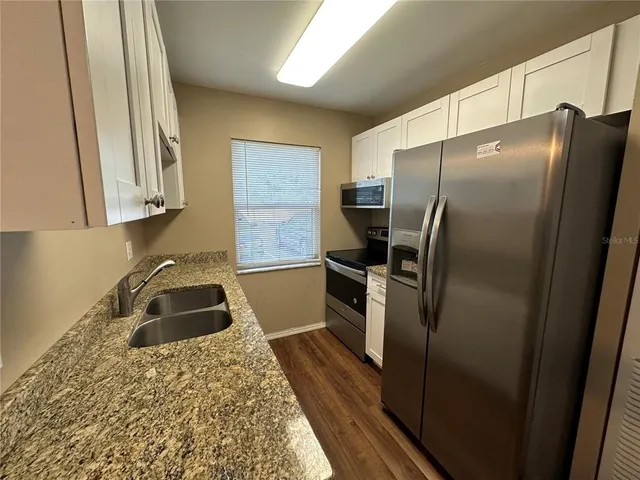 a kitchen with a refrigerator and a sink