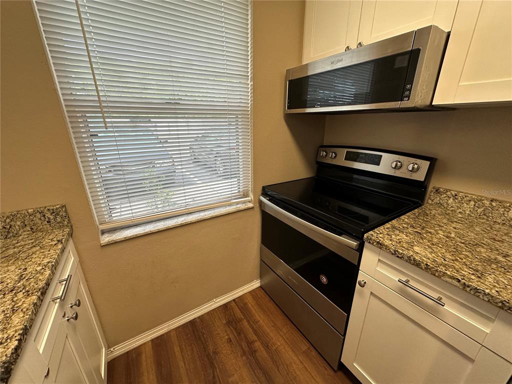 2440 Enterprise Road, Unit 2 Clearwater, FL 33763 - Photo 6 of 19 a kitchen with a stove and a microwave