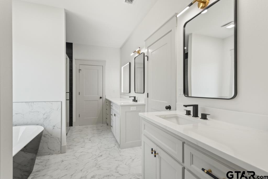 15837 Stillwaters Lindale, TX 75771 - Photo 24 of 32 a bathroom with a double vanity sink mirror and double