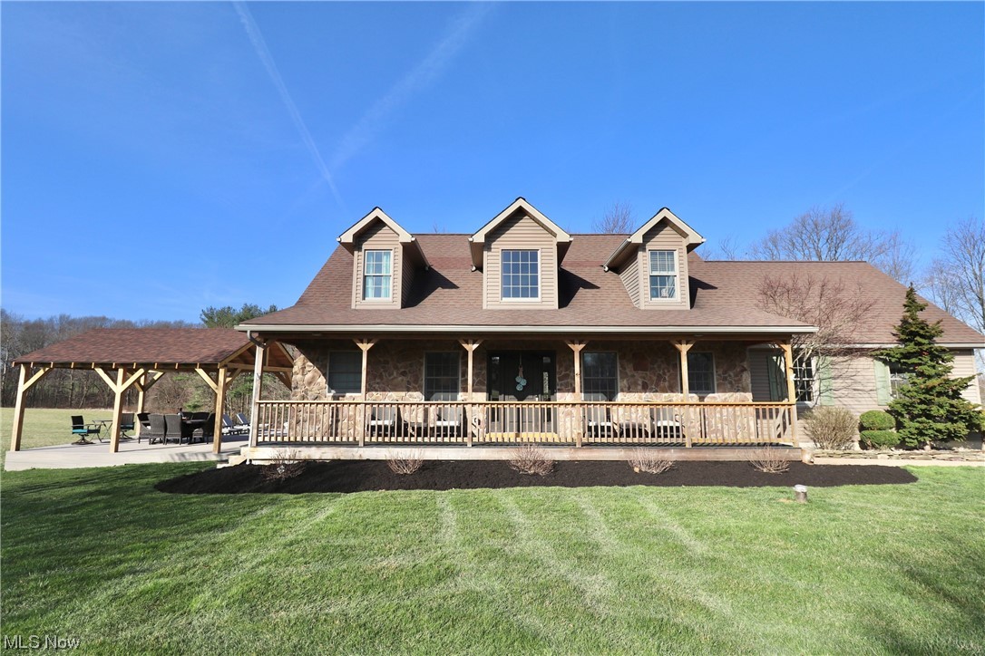 10582 Irvin Road Creston, OH 44217 - Photo 1 of 47 View of front of house featuring a front yard and a patio area