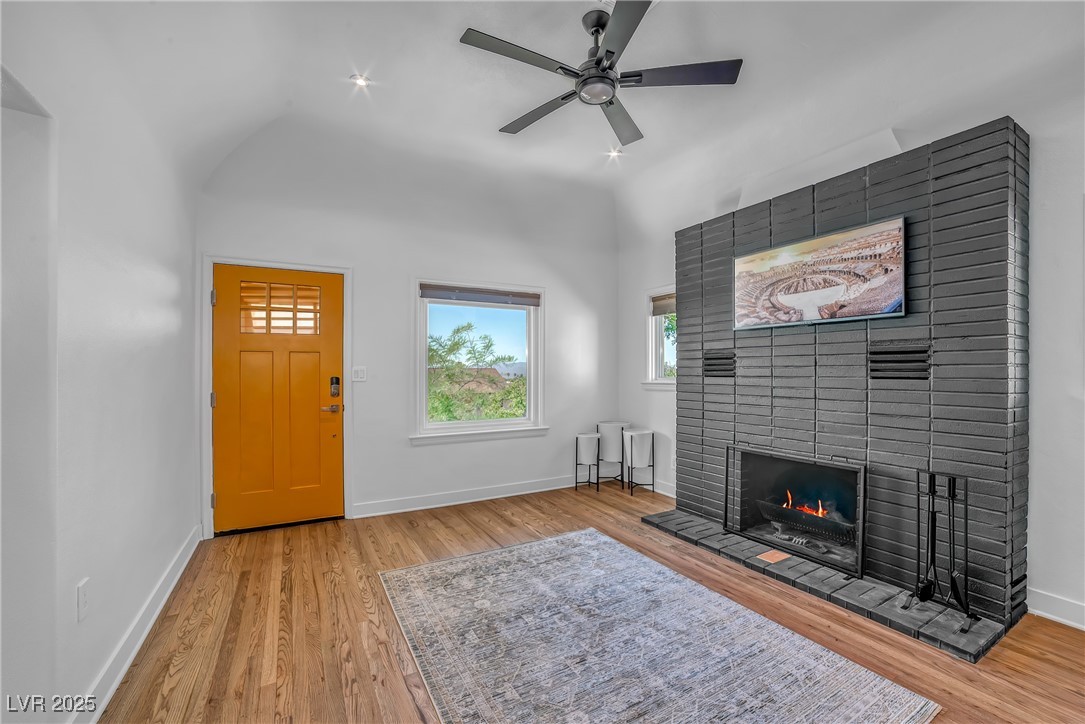 1318 Denver Street Boulder City, NV 89005 - Photo 13 of 32 Living room with vaulted ceiling, a fireplace, light wood flooring, and ceiling fan