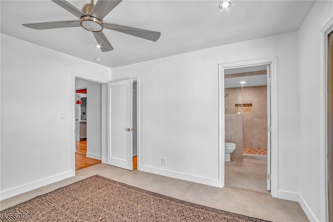 1318 Denver Street Boulder City, NV 89005 - Photo 21 of 32 Primary bedroom with ceiling fan, walk in closet, slider to back patio and ensuite bath