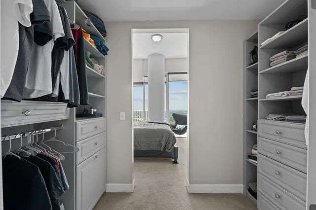 a white bath tub sitting next to a small bathroom