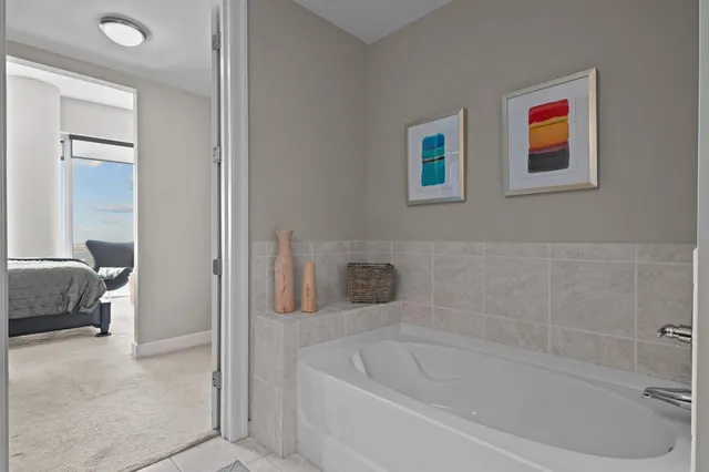 a bath tub sitting next to a white sink