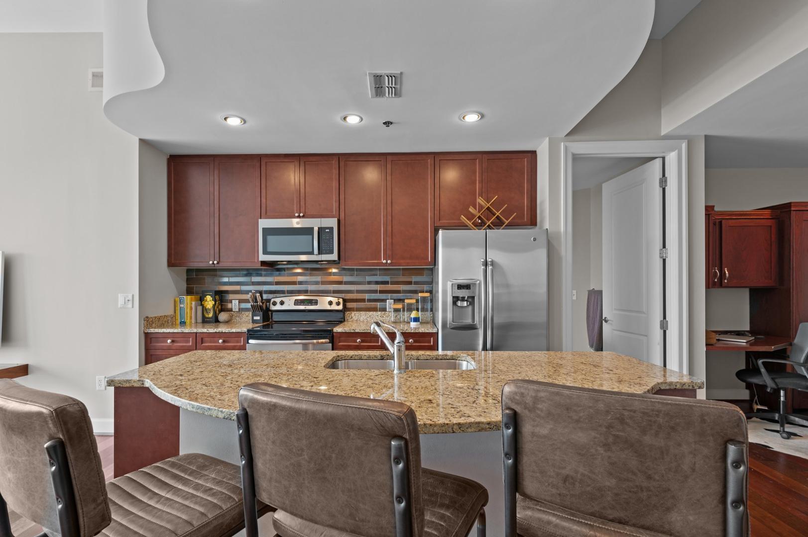 301 Fayetteville Street, Unit 33111 Raleigh, NC 27601 - Photo 10 of 64 a kitchen with stainless steel appliances a refrigerator and a stove top oven