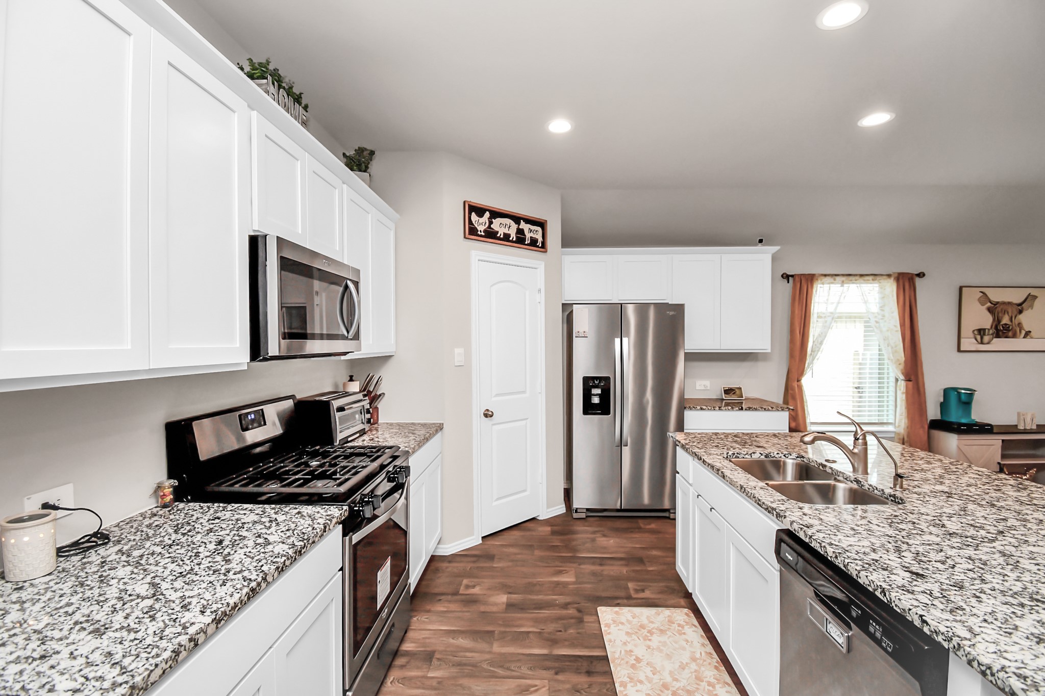 3610 Crimson Embers Lane Conroe, TX 77301 - Photo 12 of 41 a kitchen with granite countertop a sink stove and refrigerator
