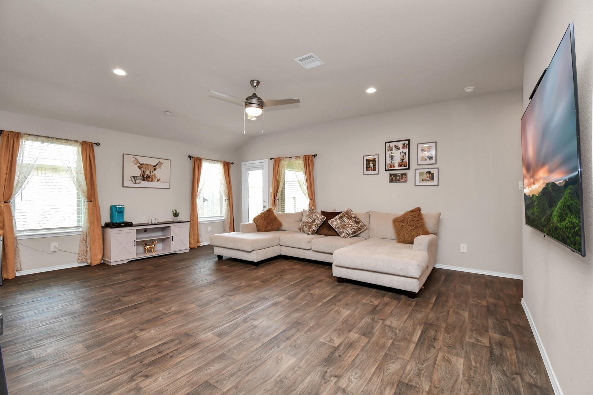 3610 Crimson Embers Lane Conroe, TX 77301 - Photo 17 of 41 a living room with furniture and a flat screen tv