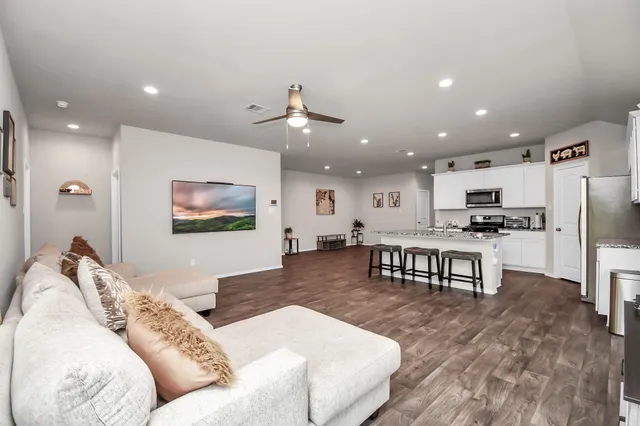a living room with furniture and kitchen view