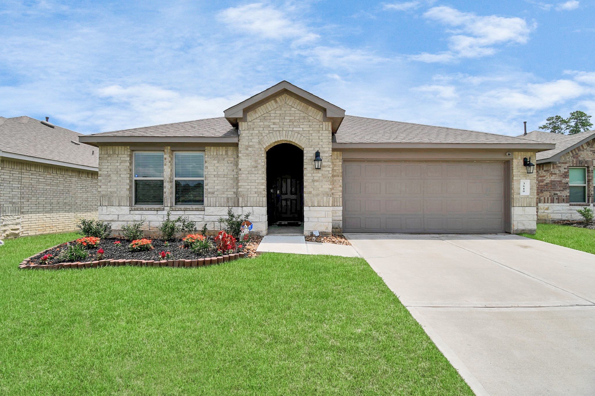 3610 Crimson Embers Lane Conroe, TX 77301 - Photo 2 of 41 a front view of a house with a garden and plants