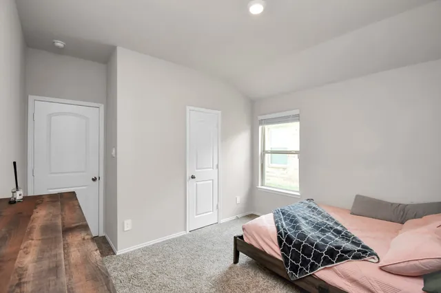 a bedroom with bed and window
