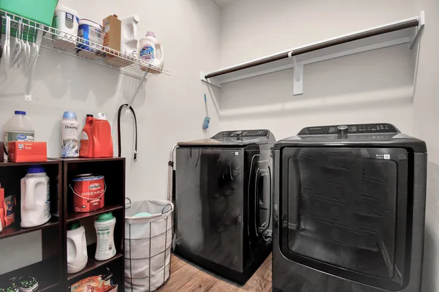 a utility room with closet and wooden floor