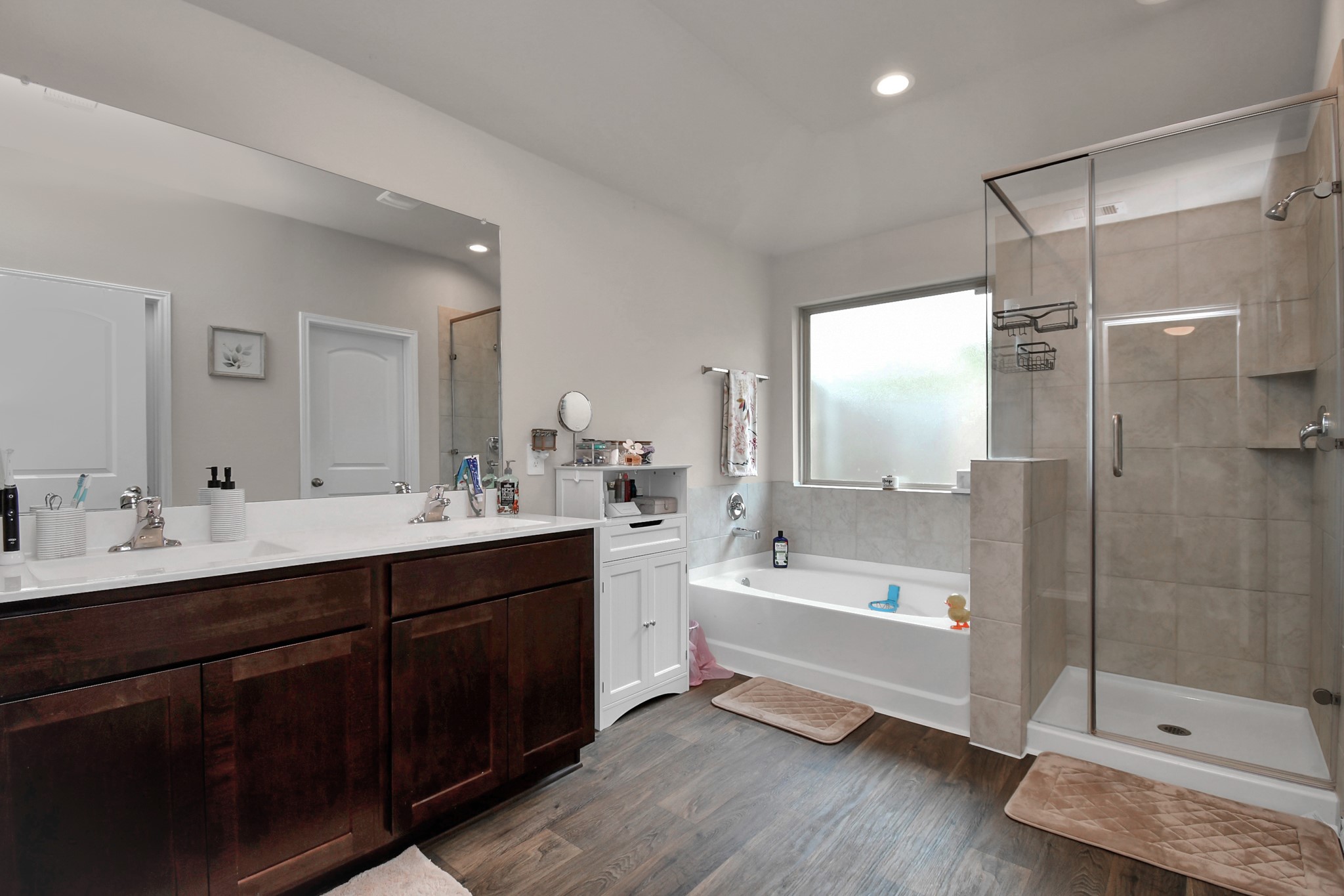 3610 Crimson Embers Lane Conroe, TX 77301 - Photo 29 of 41 a bathroom with a tub a sink shower and mirror