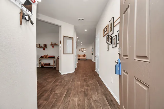 a view of a living room with furniture and wooden floor