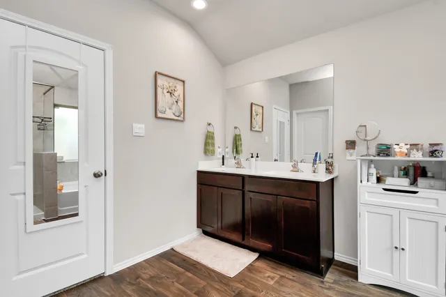 a bathroom with a sink vanity and mirror