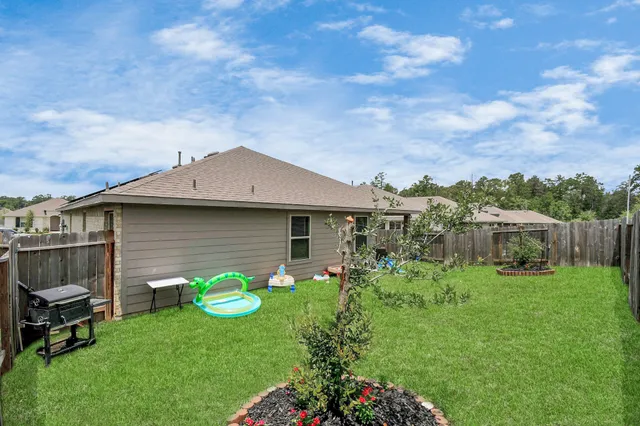 a backyard of a house with table and chairs