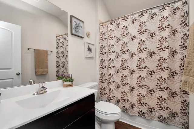 a bathroom with a sink toilet and mirror