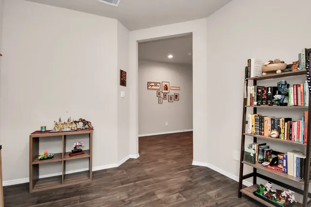 a view of a workspace with furniture and wooden floor