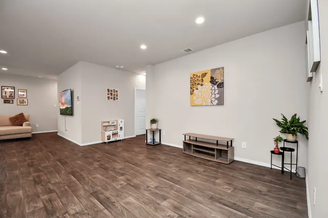 a view of room with furniture and wooden floor