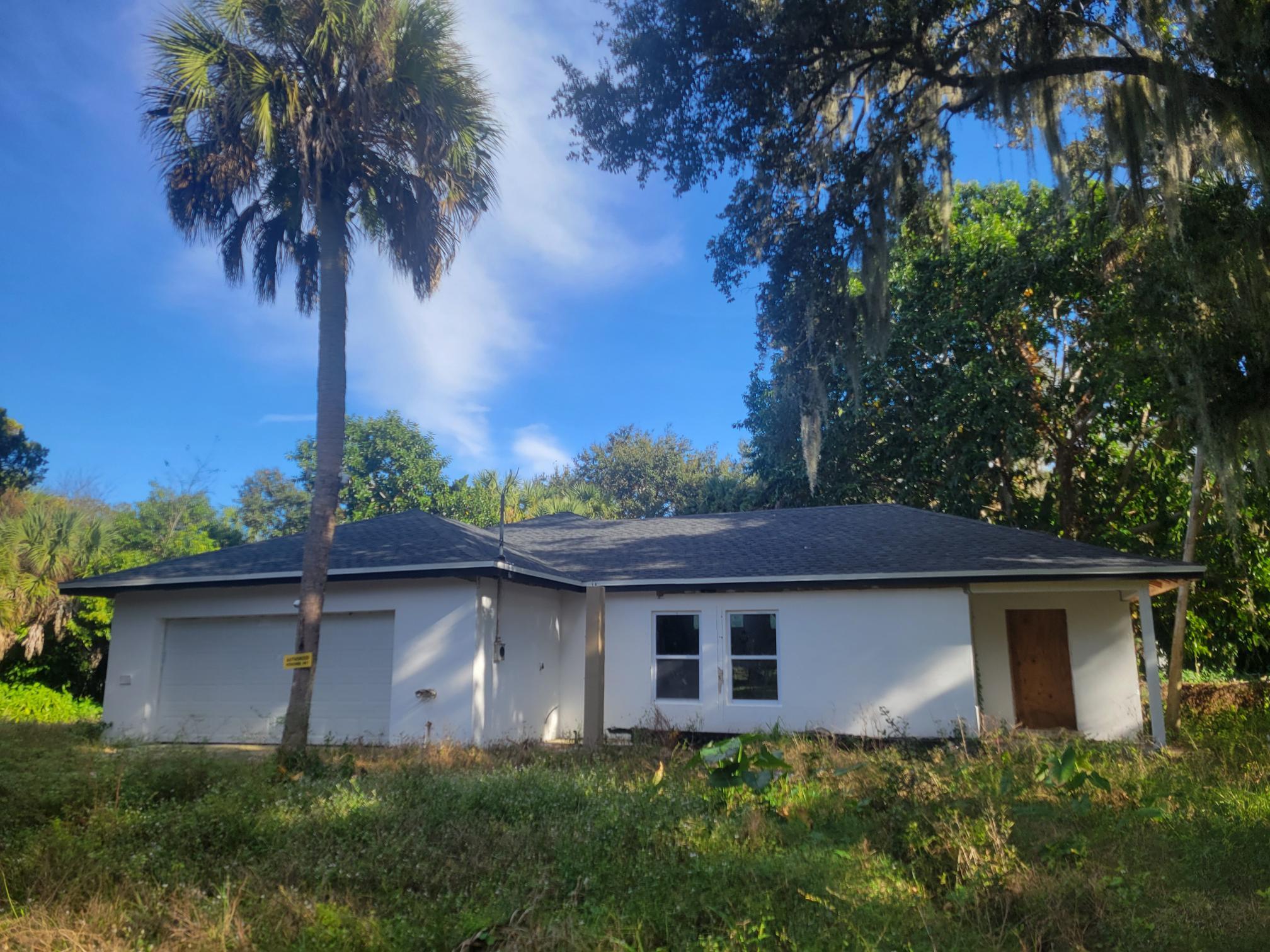 1817 Palm Boulevard Melbourne, FL 32901 - Photo 1 of 35 a view of a yard in front of a house with a large tree