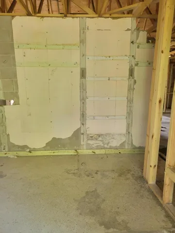 a view of an empty room with cabinet and a window