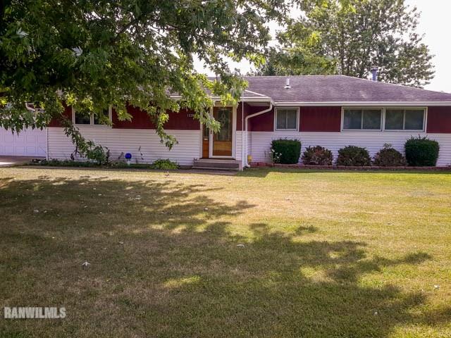 12289 Tresemer Road Roscoe, IL 61073 - Photo 1 of 25 a front view of a house with a garden and trees