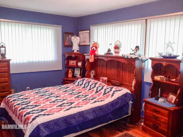 12289 Tresemer Road Roscoe, IL 61073 - Photo 11 of 25 a bed sitting in a bedroom next to a window