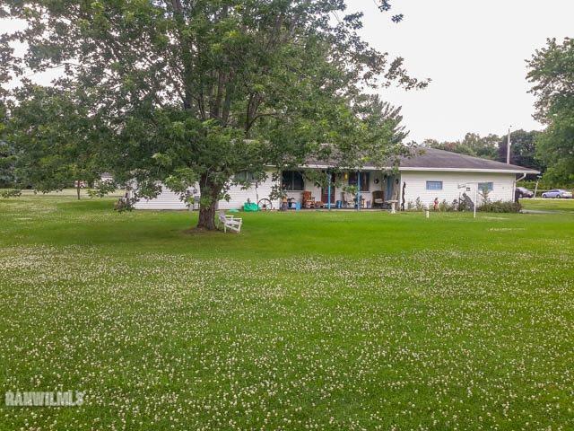 12289 Tresemer Road Roscoe, IL 61073 - Photo 21 of 25 a front view of a house with a garden