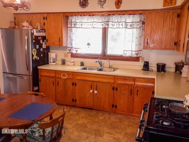12289 Tresemer Road Roscoe, IL 61073 - Photo 6 of 25 a kitchen with stainless steel appliances granite countertop a sink stove and refrigerator