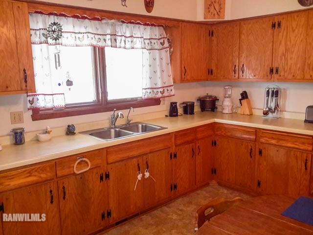 12289 Tresemer Road Roscoe, IL 61073 - Photo 7 of 25 a kitchen with a sink and cabinets
