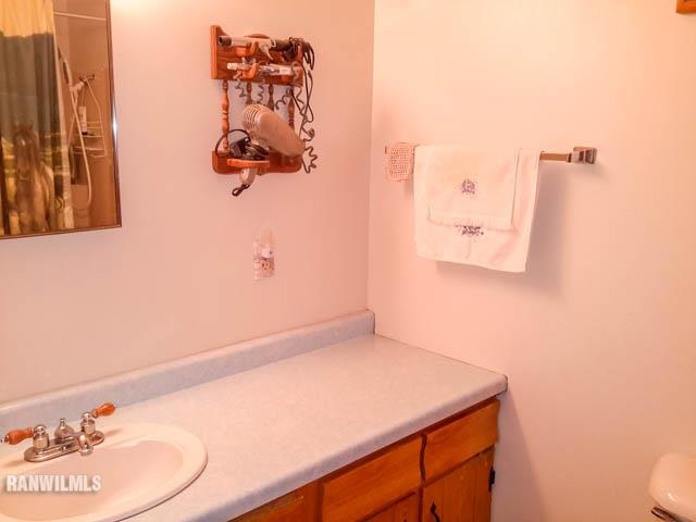 12289 Tresemer Road Roscoe, IL 61073 - Photo 9 of 25 a bathroom with a sink and a mirror