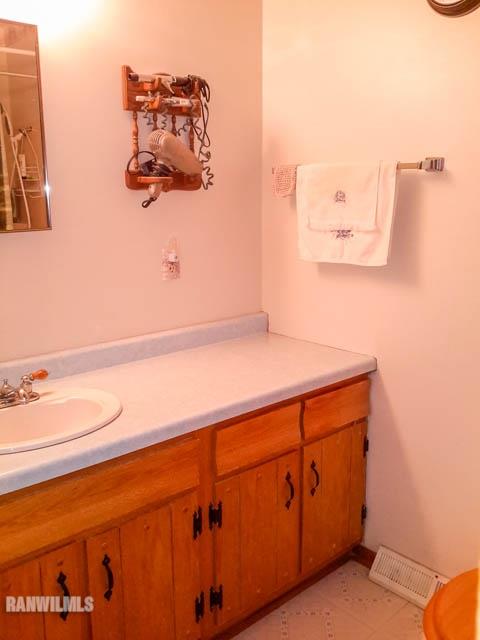 12289 Tresemer Road Roscoe, IL 61073 - Photo 10 of 25 a bathroom with a sink and a mirror