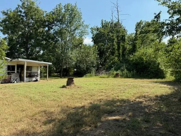 a backyard of a house with yard and trampoline