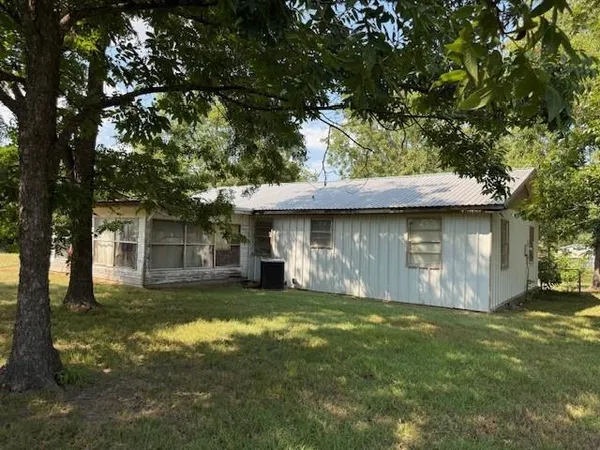 a view of a yard with a large tree