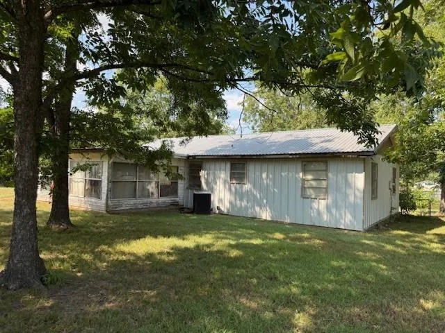 a view of a yard with a large tree