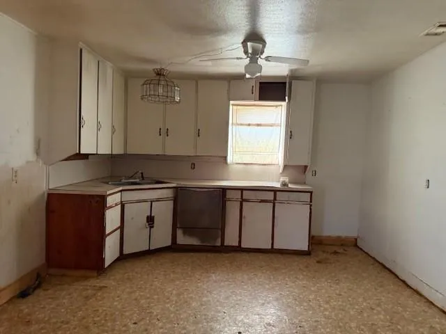 a kitchen with a sink cabinets and window