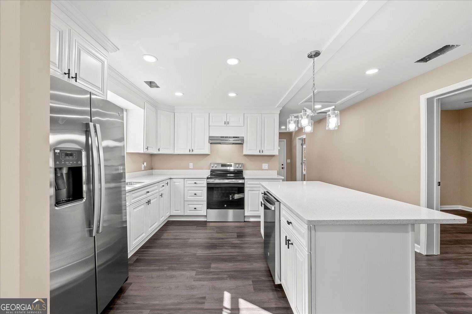 401 Baltimore Road Washington, GA 30673 - Photo 11 of 22 a kitchen with white cabinets and stainless steel appliances