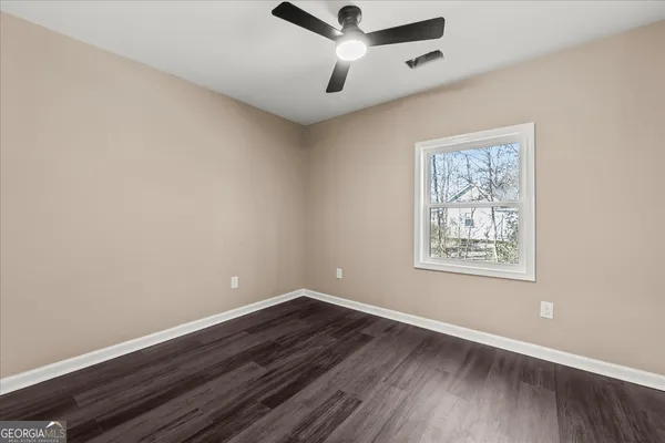 a view of an empty room and wooden floor