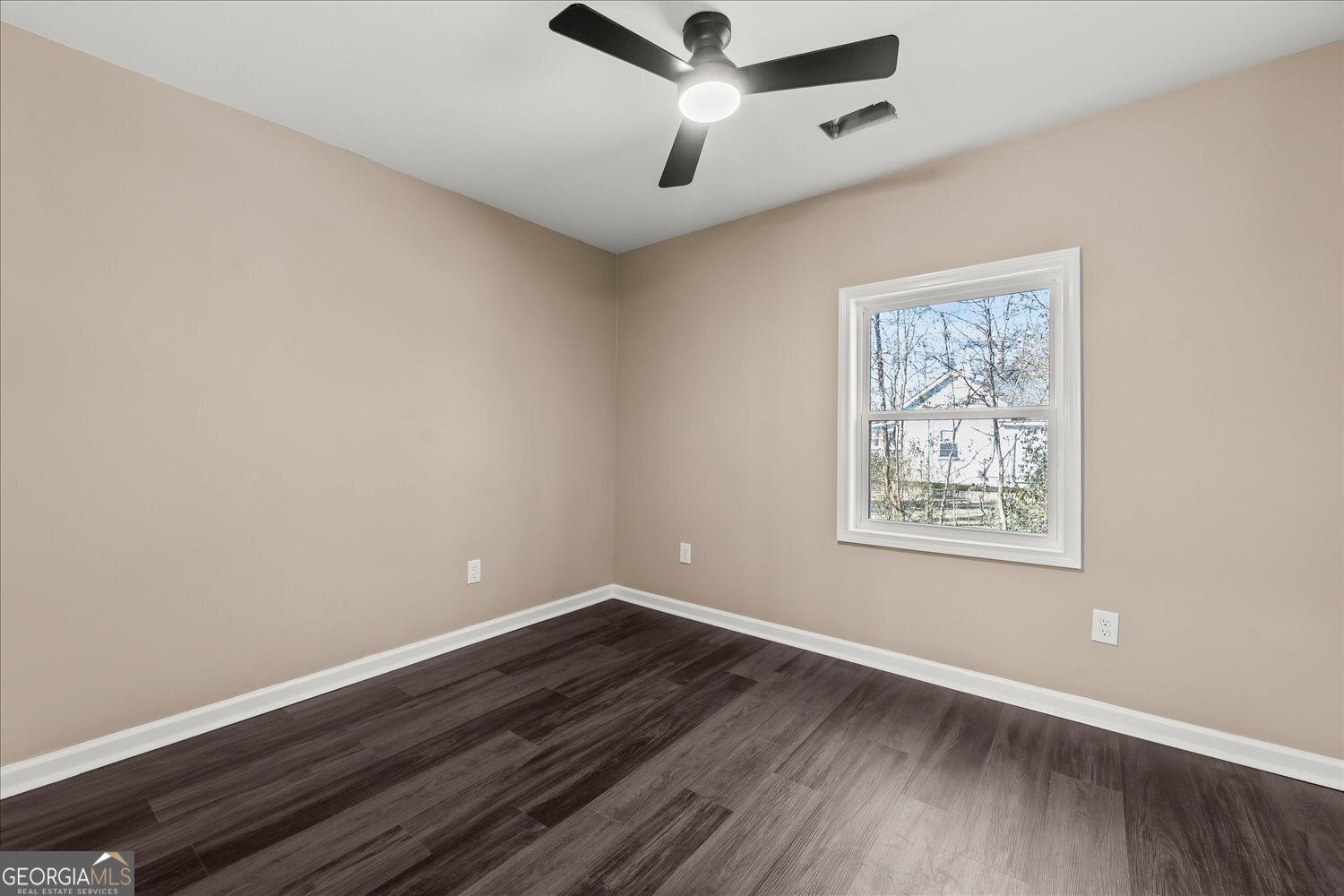 401 Baltimore Road Washington, GA 30673 - Photo 13 of 22 a view of an empty room with wooden floor and a window