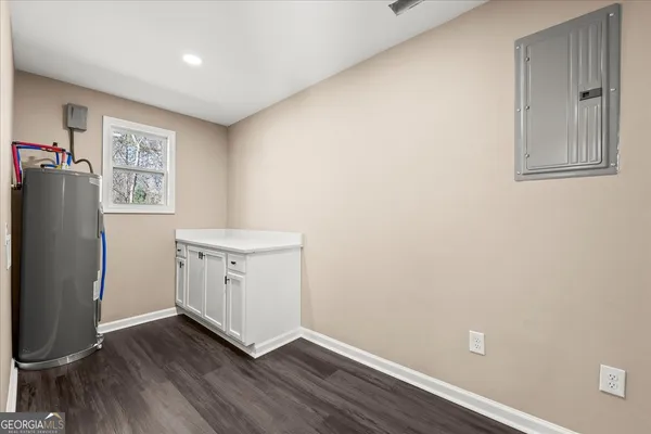a view of wooden floor and a chandelier fan in a room