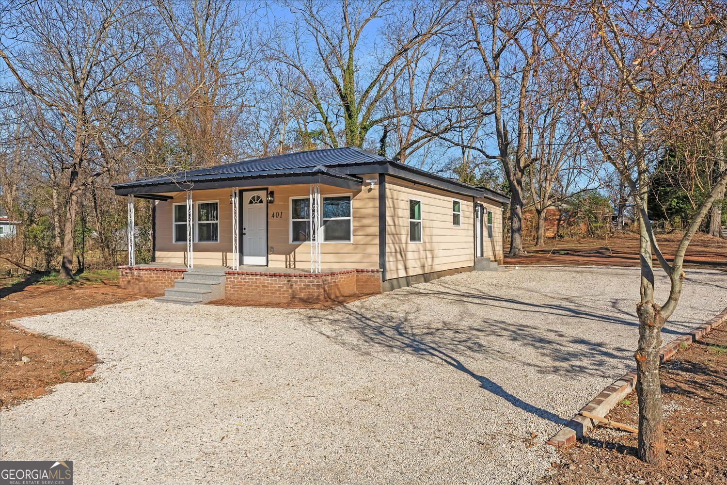 401 Baltimore Road Washington, GA 30673 - Photo 2 of 22 a house with trees in the background