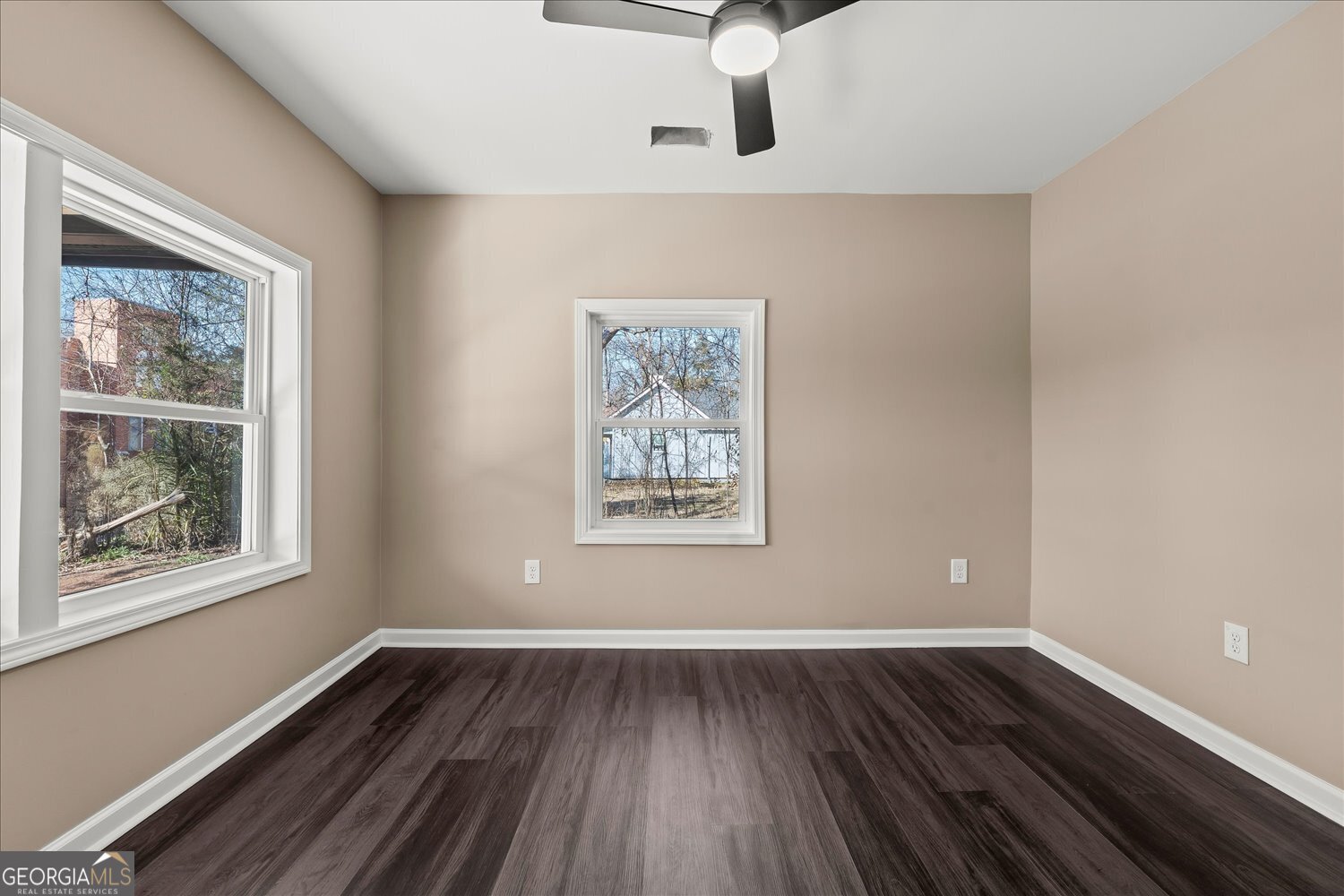 401 Baltimore Road Washington, GA 30673 - Photo 5 of 22 a view of an empty room with wooden floor and a window