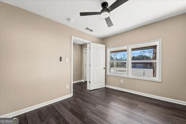 a view of wooden floor and windows in a room